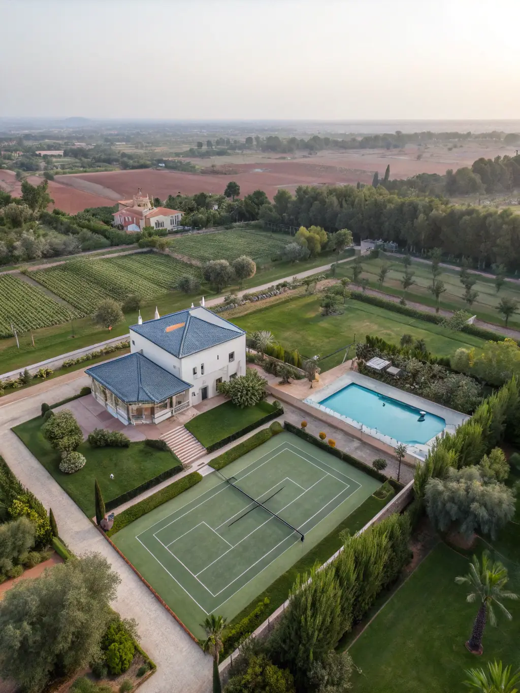 A luxurious villa in Marrakech with a private pool, surrounded by lush gardens, showcasing traditional Moroccan architecture and modern amenities.